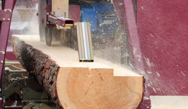 log being cut up into wood boards
